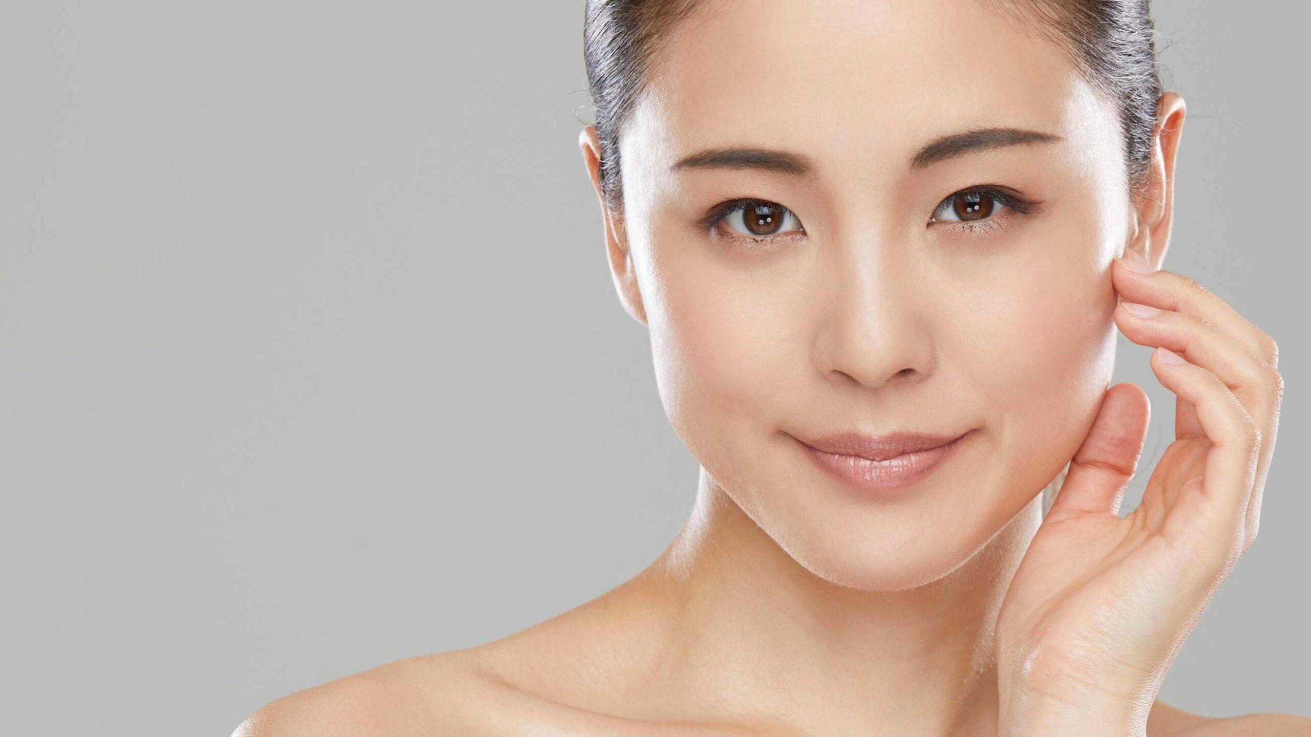 a beautiful woman holder her face