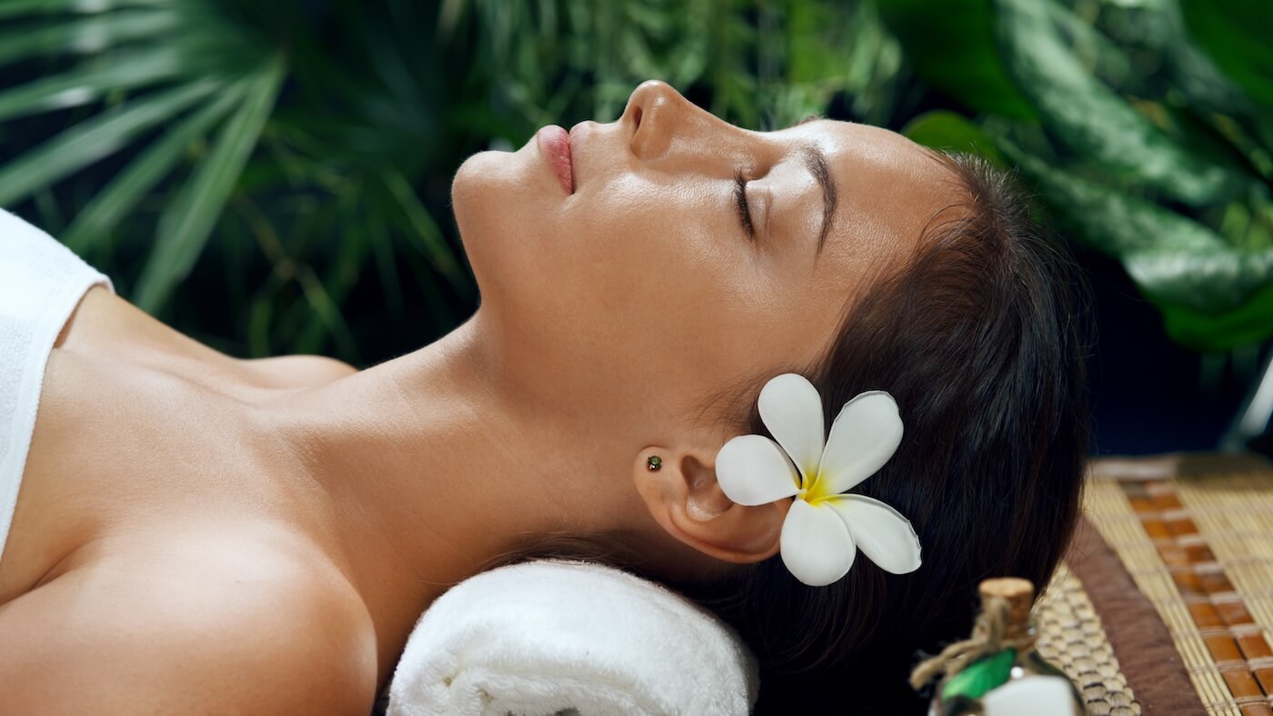 woman laying on towel